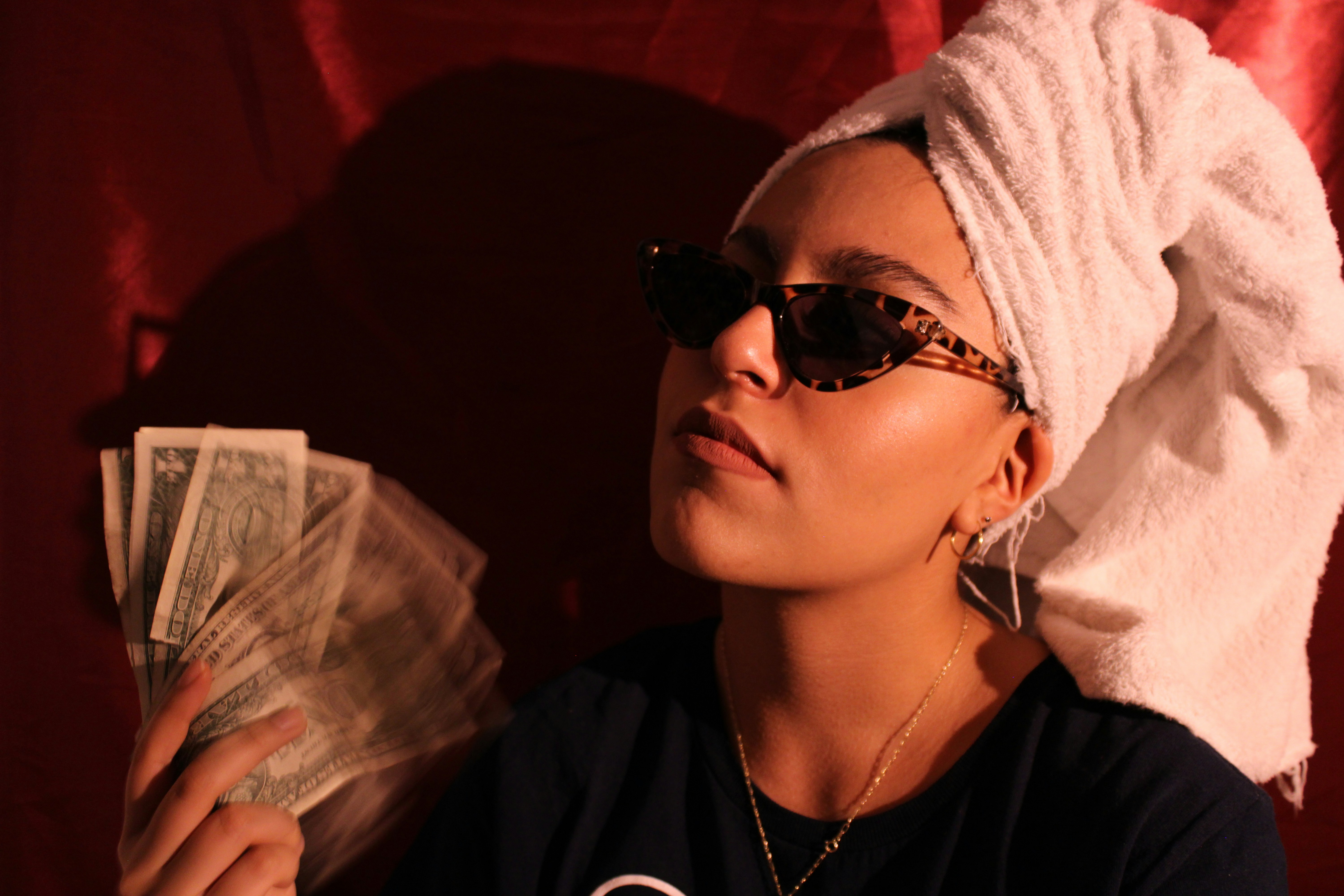 Confident woman holding a fan of cash